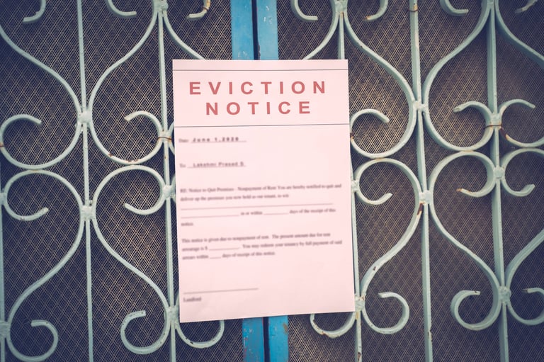 Foreclosed or eviction notice on a main door with blurred details of a house with vintage filter