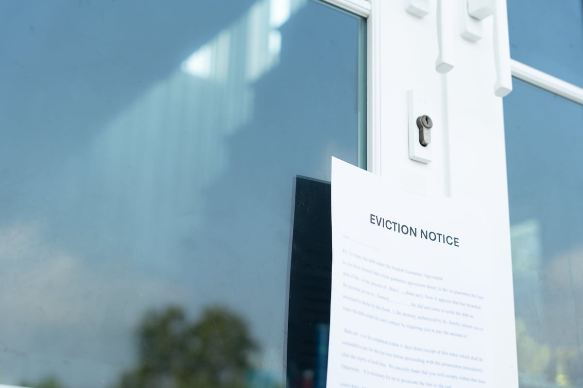 Eviction notice stuck on the door of a house by civil servant, bankruptcy and dispossession concept