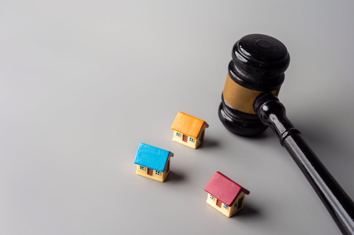 A gavel and colorful miniature houses, real estate auction or foreclosure property law concept