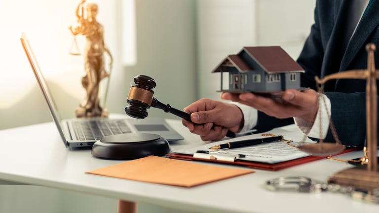 Miniature house, foreclosure auction, lawyer, wooden hammer on table