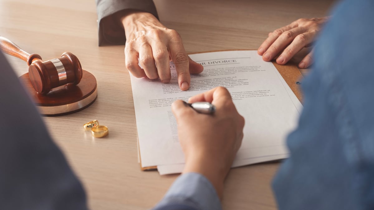 Divorce decree form with a ring, representing spouse relief and separation of liability