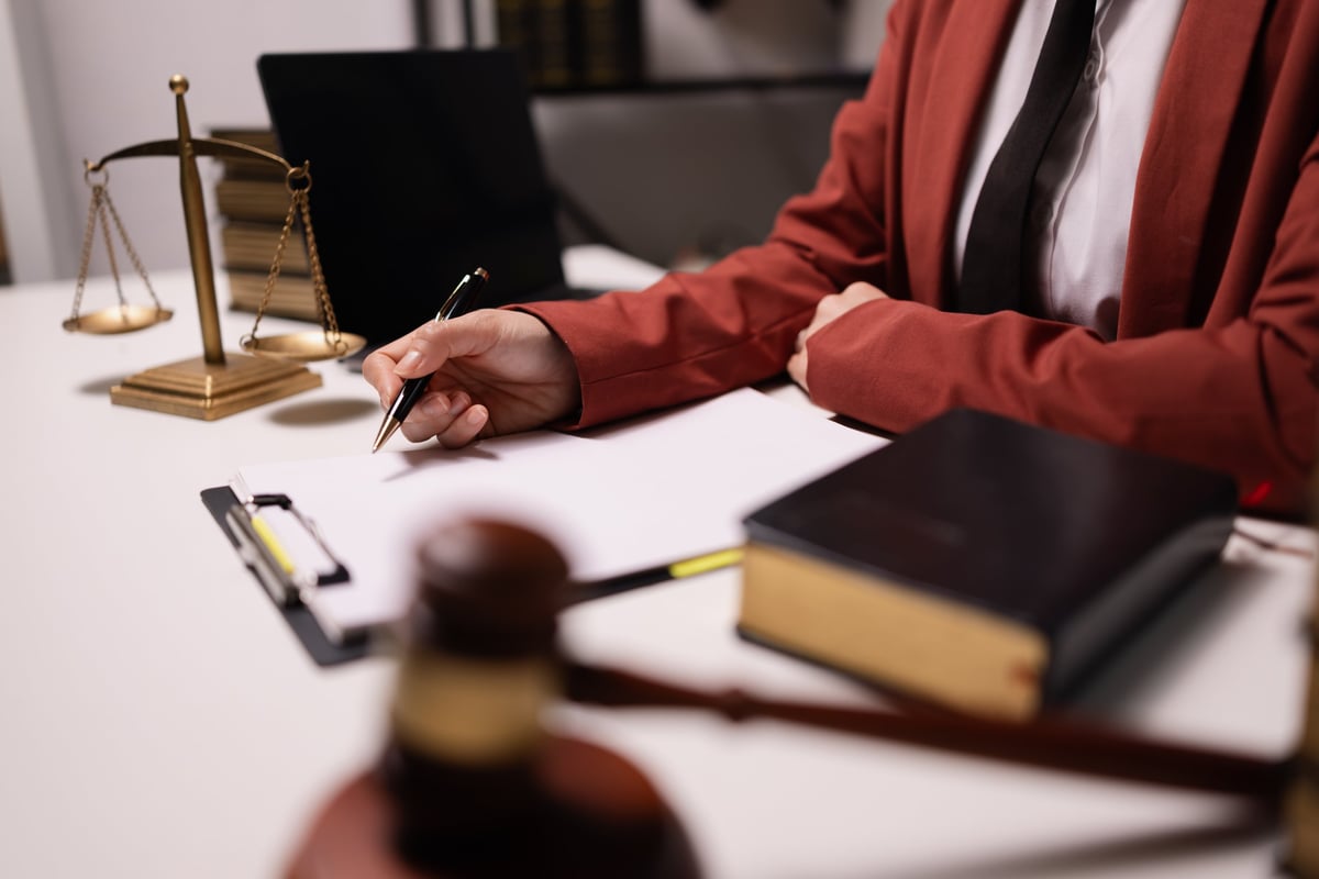 Lawyer businesswoman working diligently with a signature document in a modern office, signing contract, justice and lawyer concept
