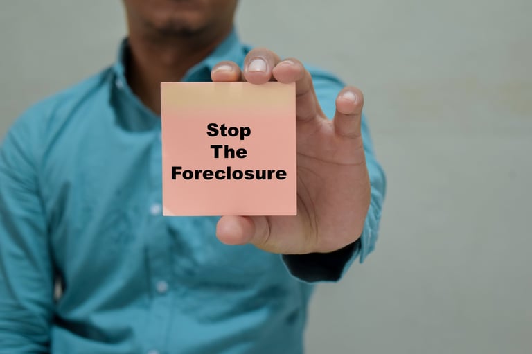 Businessman holds card with stop the foreclosure message