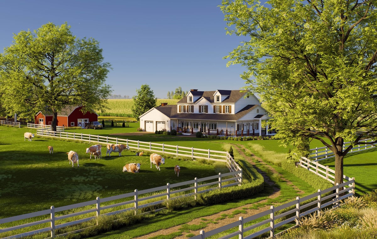 Horizontal view of a large white farmhouse and red barn with a herd of cows grazing on a green pasture enclosed by white fences under a blue sky.